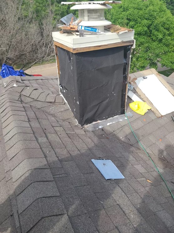 Chimney structure under repair in preparation for new chimney cap installation.