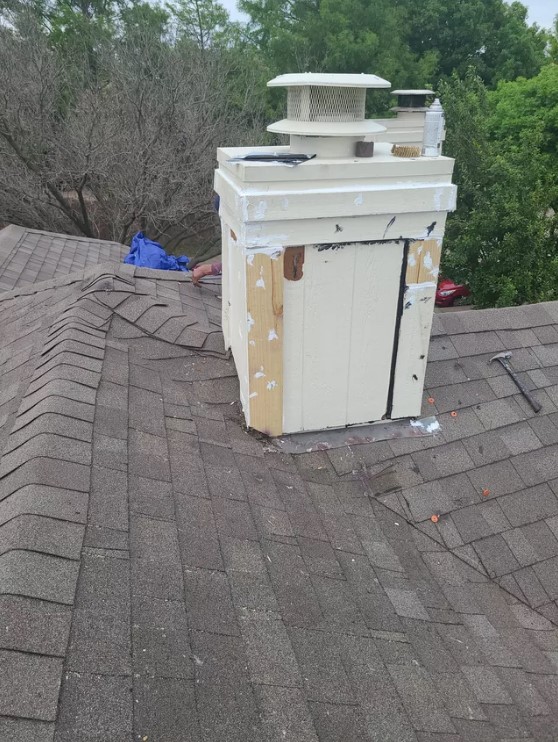 Completed chimney cap installation with fresh exterior repair and sealing.