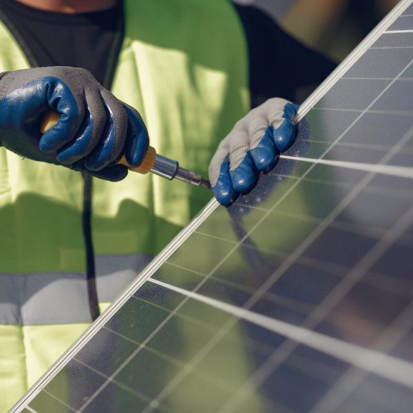 Engineer in a white helmet. Man near solar panel.