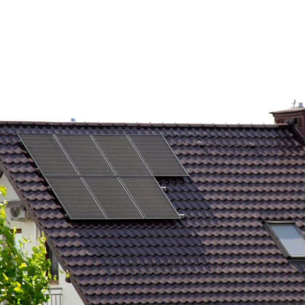 Installing a Solar Cell on a Roof. Solar panels on roof. Historic farm house with modern solar panels on roof and wall. High quality photo