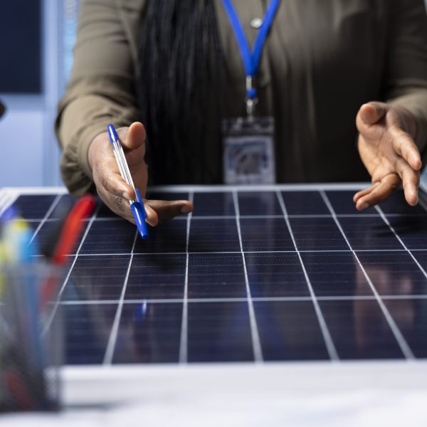 Scientists conduct research and development on solar panel efficiency, analyzing photovoltaic materials in high tech factory to enhance renewable energy production, close up shot