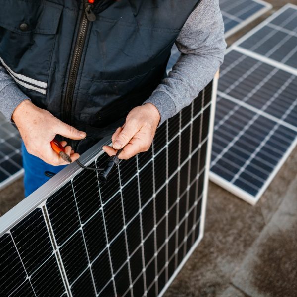Worker installing new solar panels. Eco concept alternative energy. High quality photo