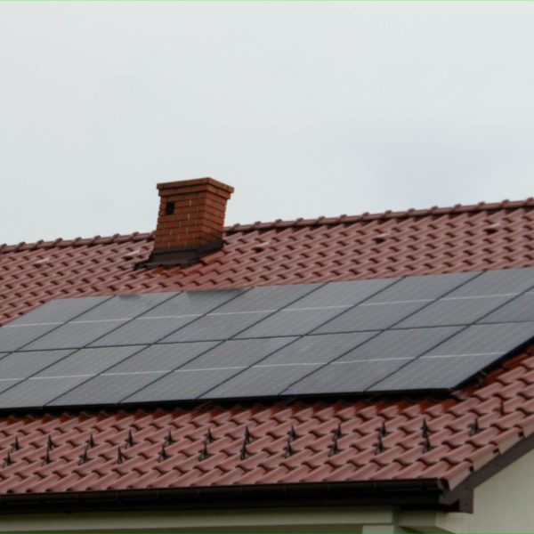 Historic farm house with modern solar panels on roof and wall Illustration
