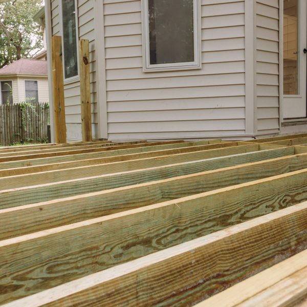 Building a patio with wooden porch terrace flooring in patio outside the new house